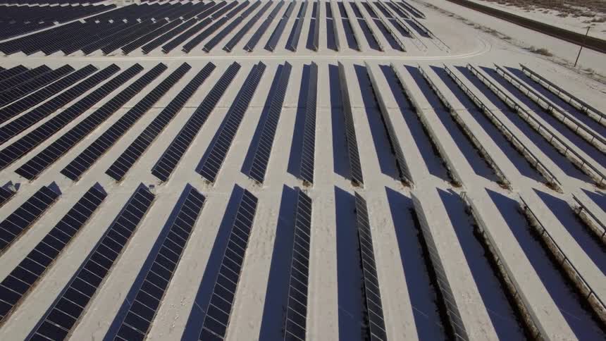 Rows and rows of solar panels in a desert