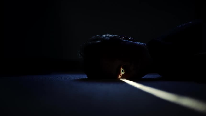 A light is shining on the persons one eye