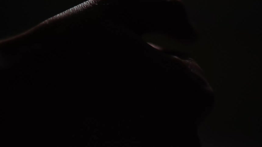 Man moving his sweaty hand around in a dark room