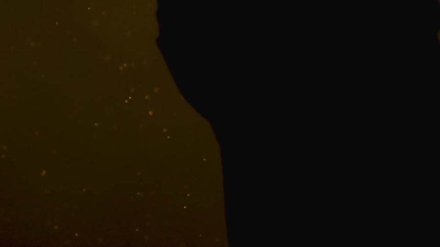 A person surrounded by sparks at night