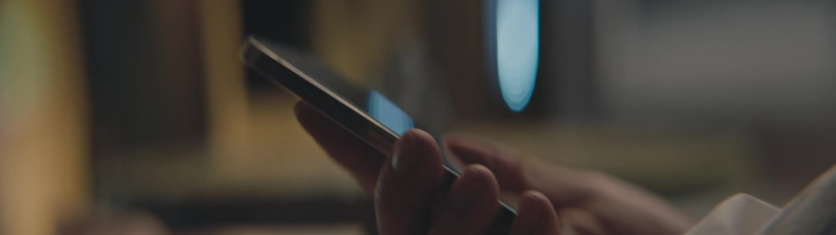 Man holding a smartphone and tapping on its screen