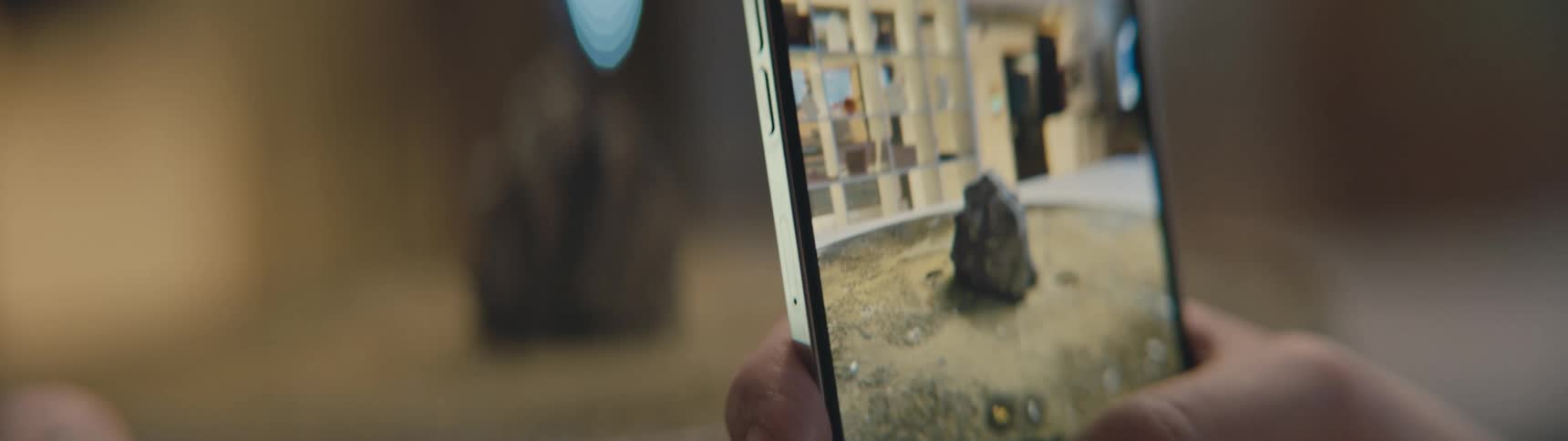 A person takes a photo of a monument with their smartphone