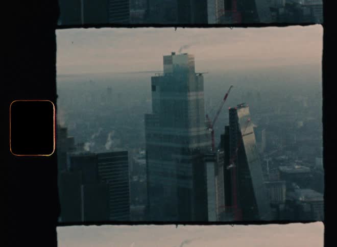A skyscraper looming over a foggy metropolis during the day