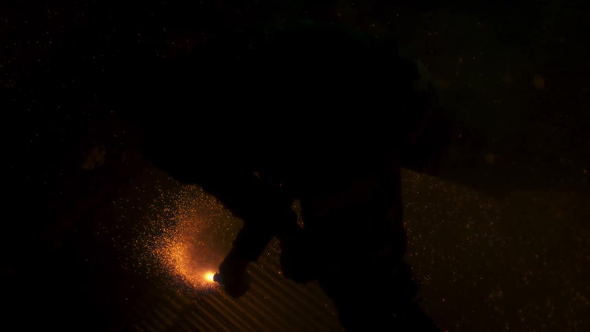 Someone waves a flare in the dark