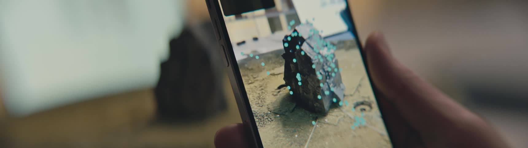 A person uses their smartphones camera to take detail shots of a sculpture
