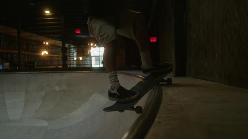 Young white man skateboarding alone at an indoor skatepark