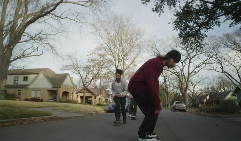A group of friend rides on skateboard in city neighbourhood
