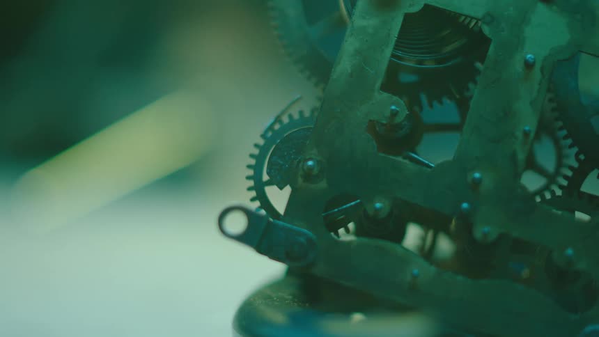 Closeup view of gears spinning in motion on a mechanism