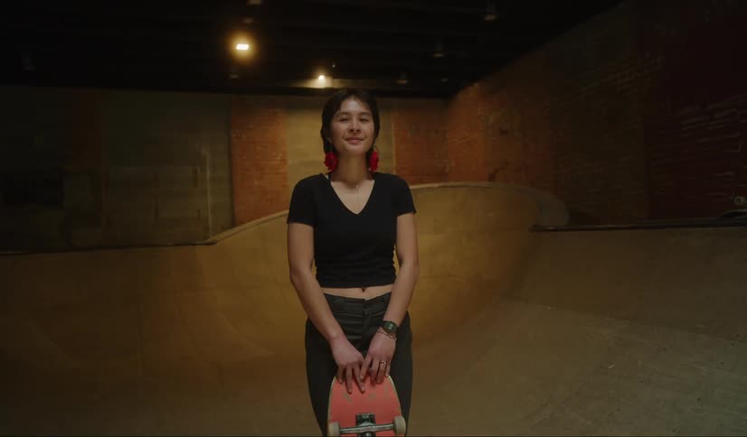 A view of a woman standing in a skate park