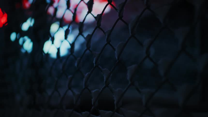 Wire fence with snow at night