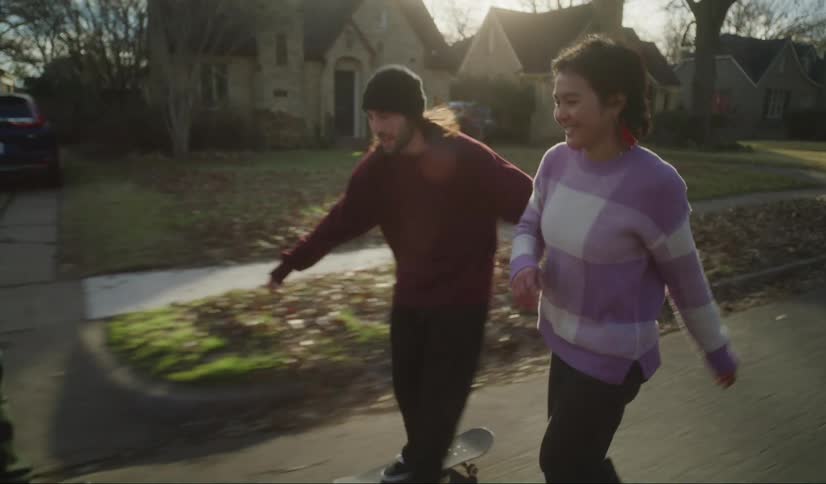 A group of young skateboarders skatboarding down the neighborhood street