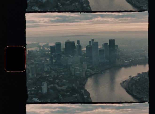 Vintage footage of an aerial view of a river going through a city
