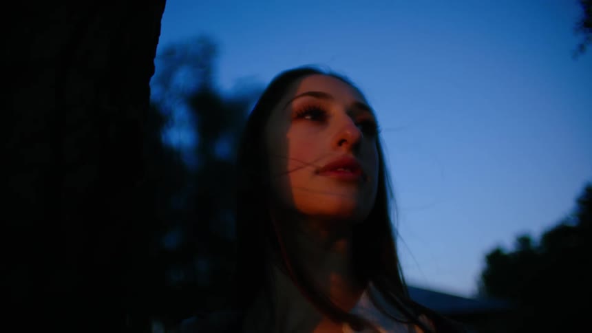 A woman moves past the tree