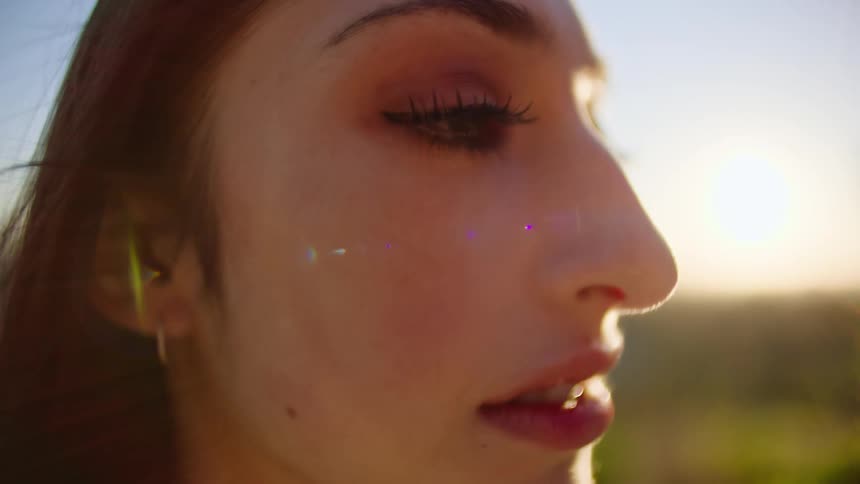A woman is crying at sunrise