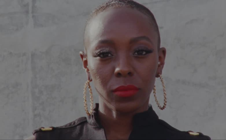 A woman is wearing large hoop earrings