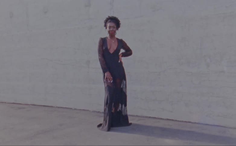 A woman is posing in a gown