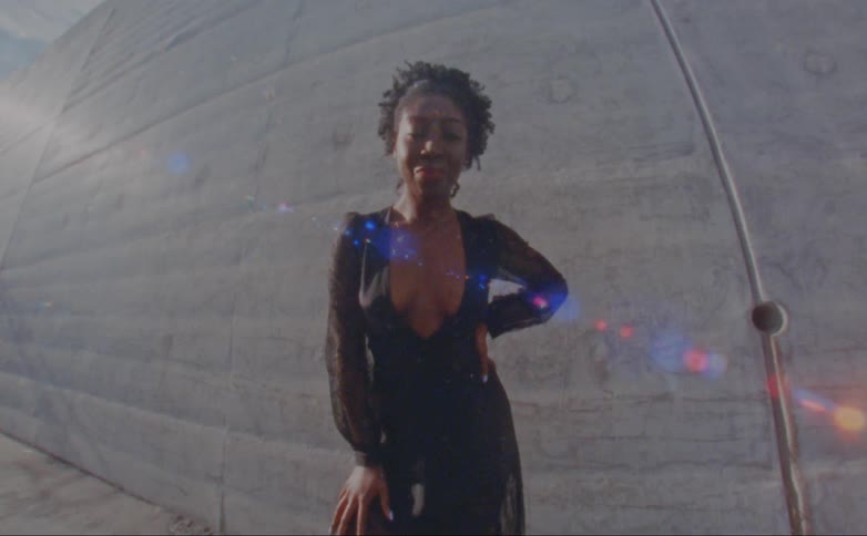 Portrait of a woman standing outdoors while wearing an evening dress
