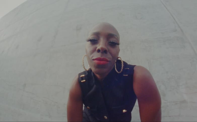 A woman leans forward outside