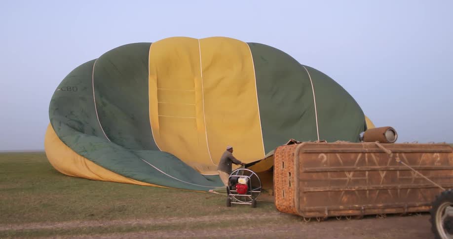 A man is filling a hot air balloon