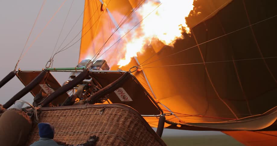 Flames burning and as they fill a hot air balloon