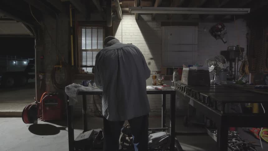 Man works on something in his workshop