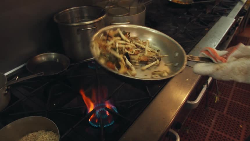 Close up of fajitas being sauted over a flame on the oven
