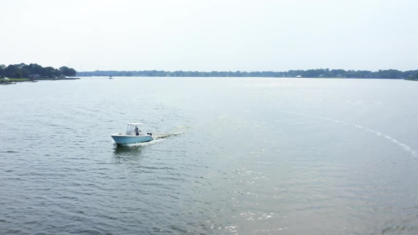 The boat is traveling in the lake