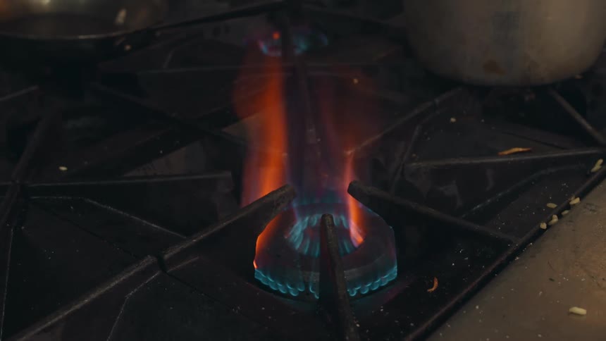 The flame on a gas stove burns
