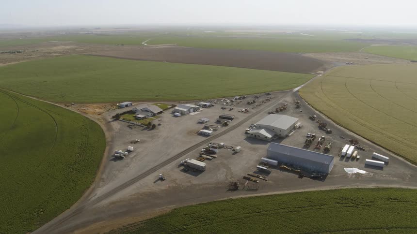 A diamond shaped farm yard compound sits between four circular crop fields