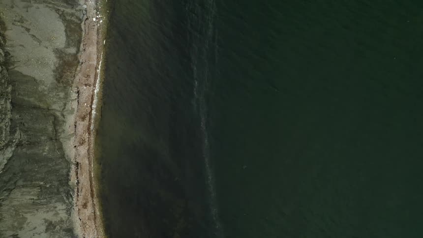 The waves crash against the shore