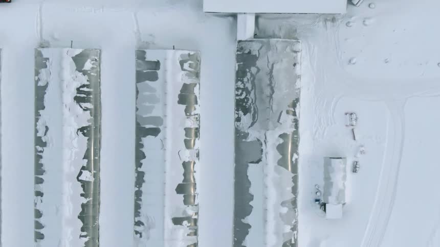 Aerial view of long buildings covered with snow on a winter day