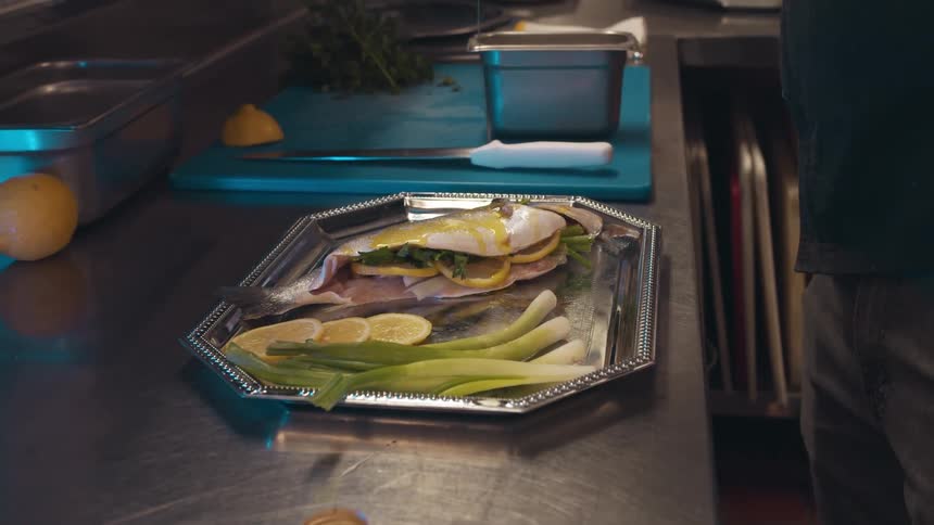 A view of someone putting sauce on food