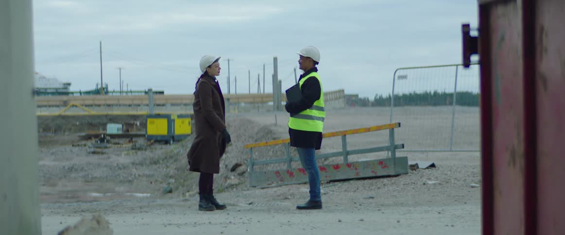 A construction worker talking to a customer