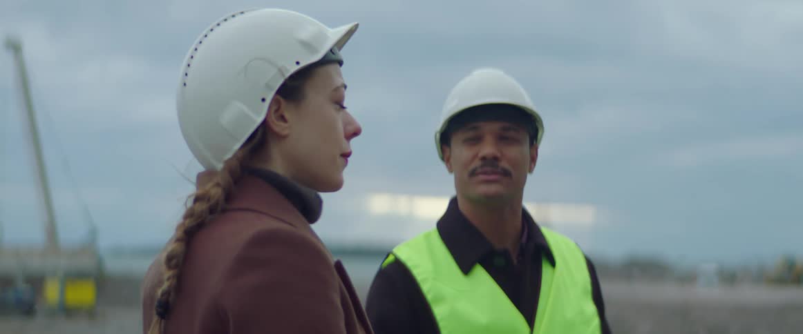 A construction worker talking to a client