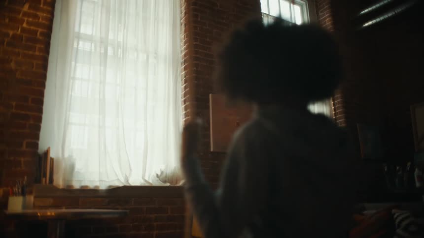 A teenager girl is swinging inside a room setting