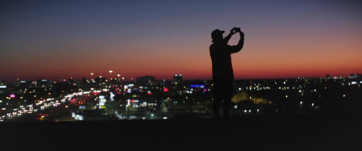 A man is taking photographs on the hill top