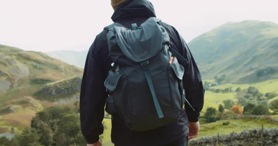 A man is hiking on the hills