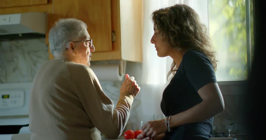 Grandmother and granddaughter cooking together, conversation