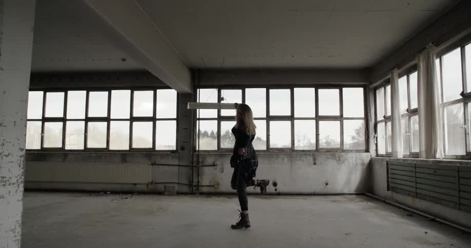 Woman dancing in an abandoned building