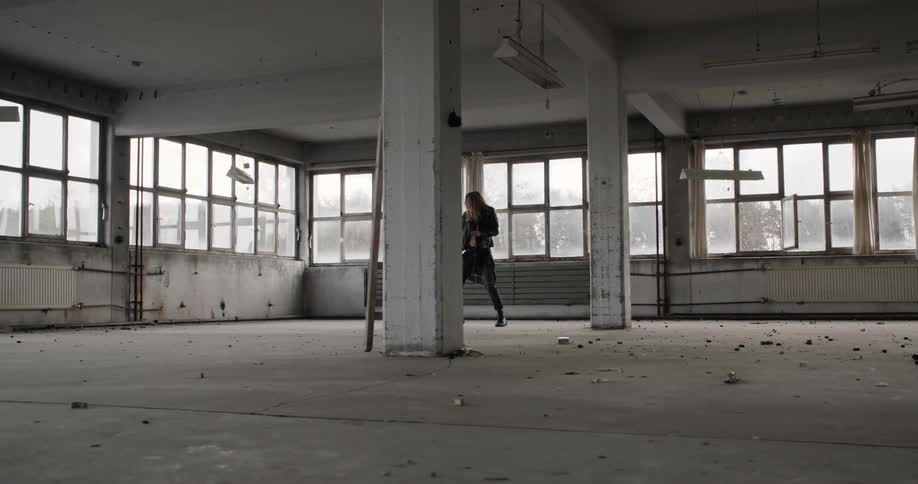 Woman dances in an abandoned studio