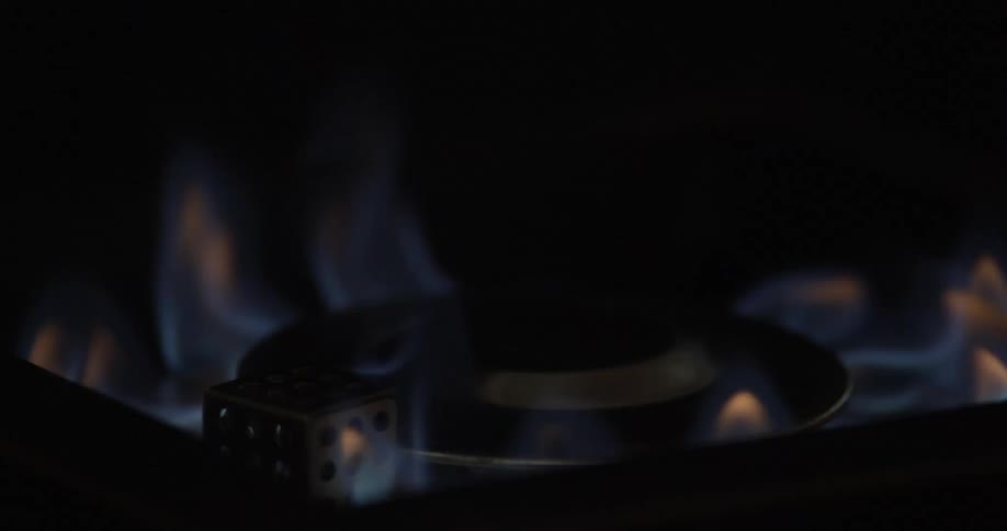 Blue flames of a gas burner in a breeze against a black background
