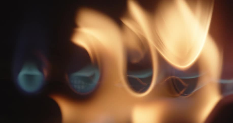 The fire lights up on the stove