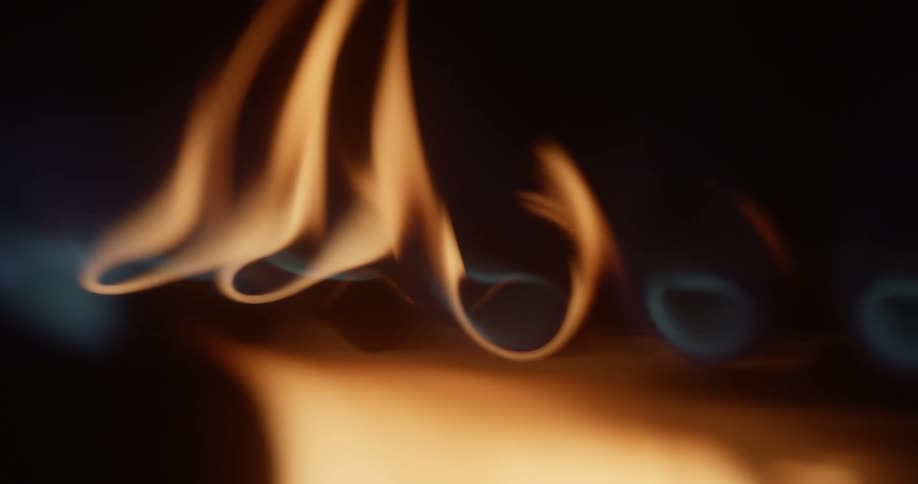 Close up view of flames burning on a gas stove