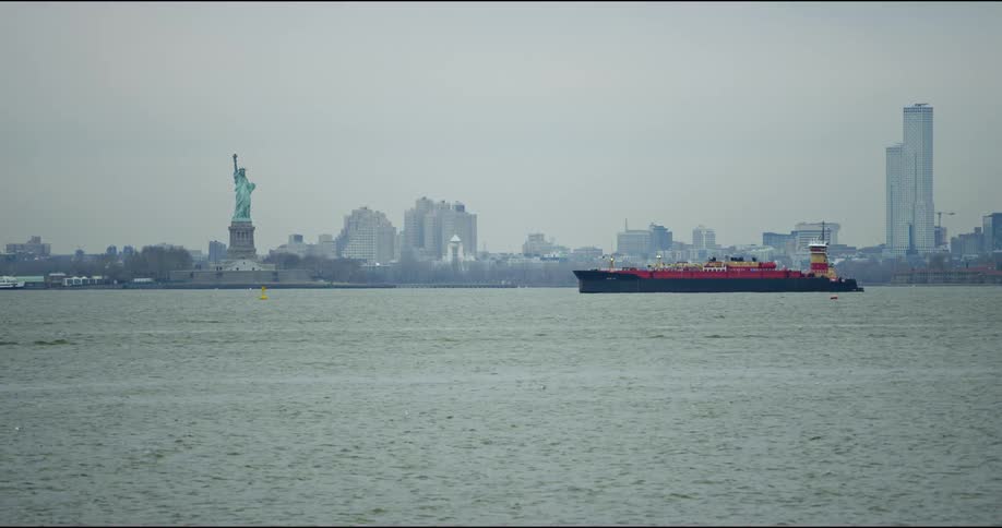 A barge is in the water by the city