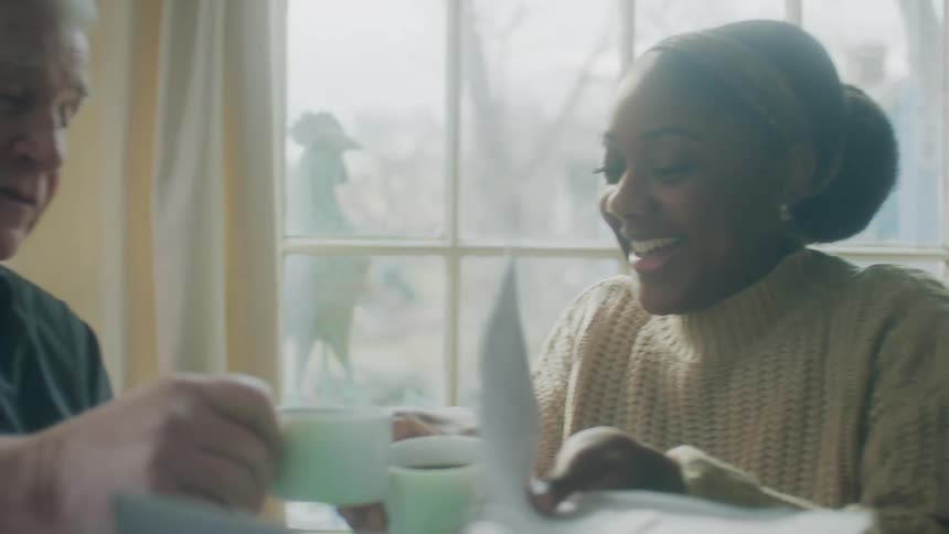 A man and woman have coffee together