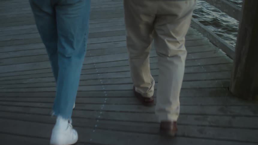 Two people walk on the pier together