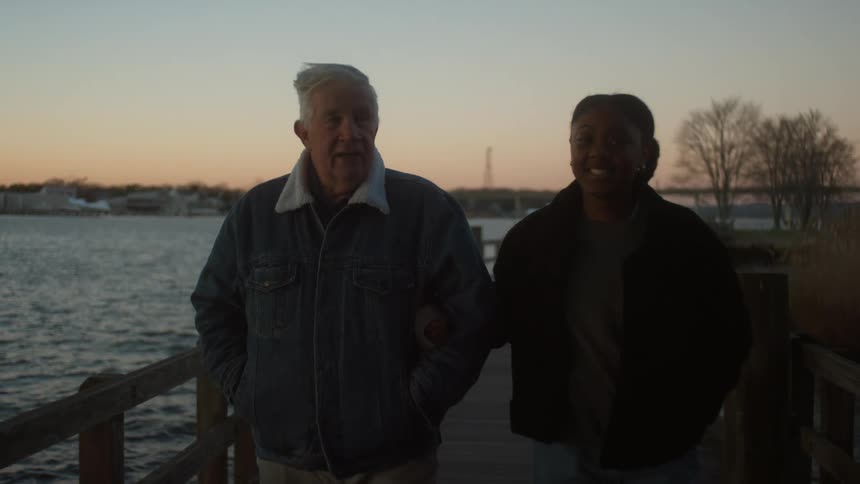 A man and woman walk together on the pier