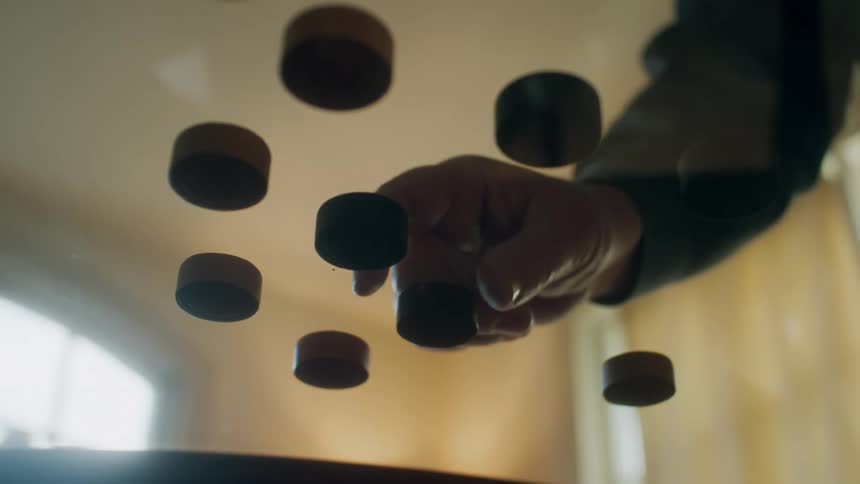 Two people are playing some sort of game with caps