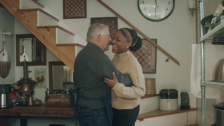 Two people dance indoors