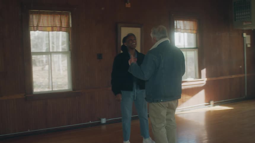 A man and woman dance in the hall